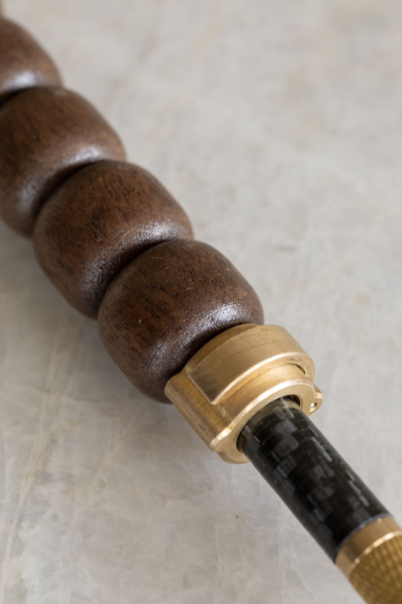 Macro detail of the brass locking collar against the carbon weave
