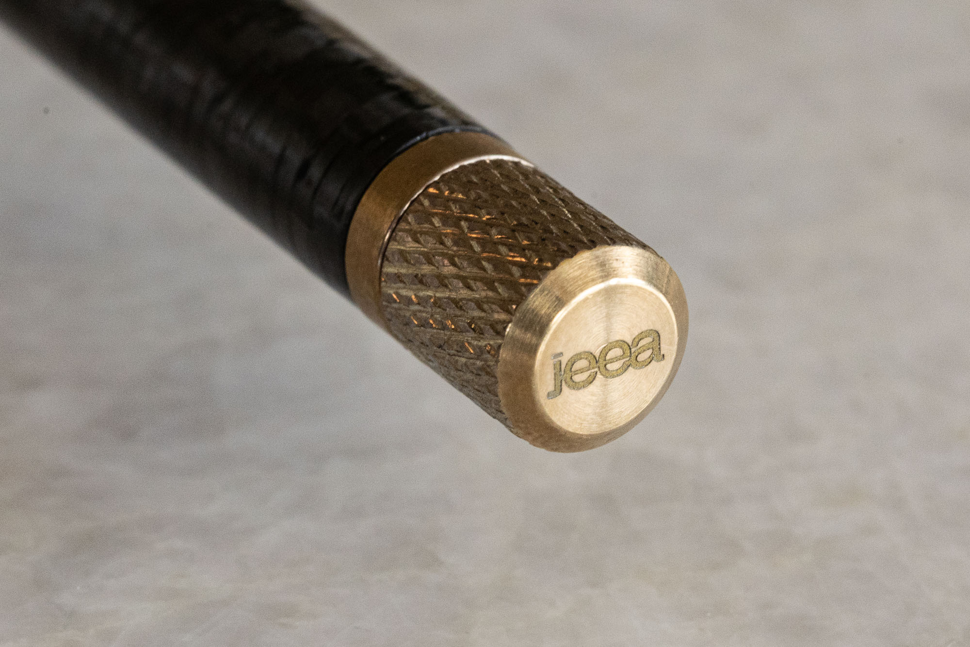 Brass end cap engraved with the jeea wordmark