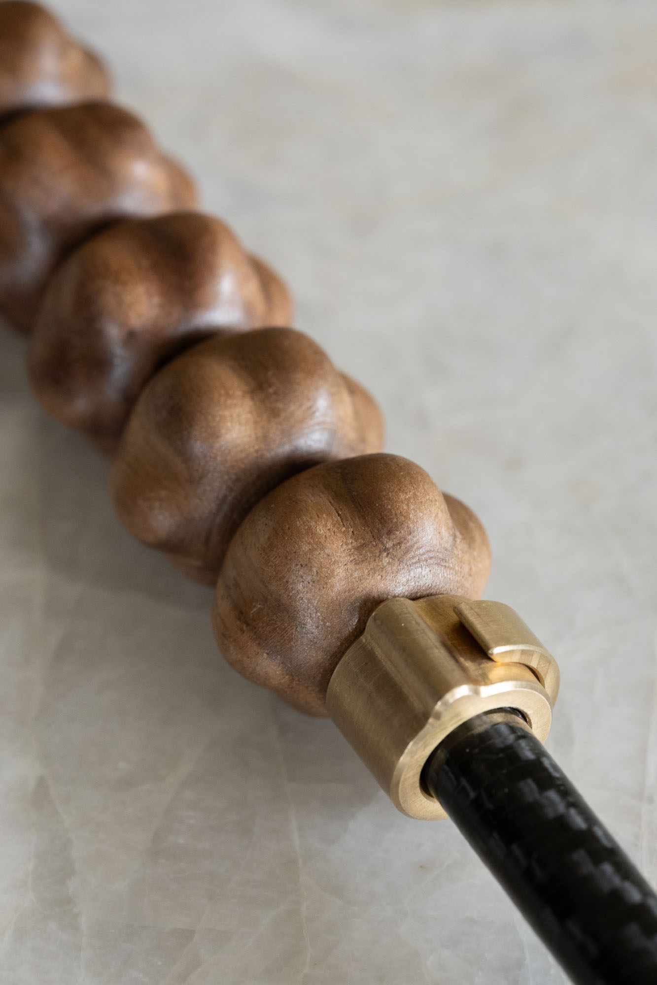 Textured hardwood beads and brass collar in macro